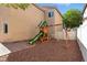 Spacious backyard with a play structure, gravel and a brick-paved patio for Gathering fun at 9004 Harbor Wind Ave, Las Vegas, NV 89178