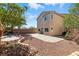 Large backyard with desert landscaping, a paver patio, and a play set at 9004 Harbor Wind Ave, Las Vegas, NV 89178