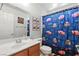 Bright bathroom with a clean single sink vanity and Cars themed shower curtain at 9004 Harbor Wind Ave, Las Vegas, NV 89178
