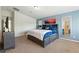 Spacious bedroom featuring carpet, neutral paint, and a king bed with blue accent pillows at 9004 Harbor Wind Ave, Las Vegas, NV 89178