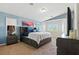 Bright Primary bedroom with blue walls, large windows, and a stylish headboard at 9004 Harbor Wind Ave, Las Vegas, NV 89178
