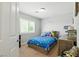 Cozy bedroom featuring a comfortable bed, window shutters, and colorful decor at 9004 Harbor Wind Ave, Las Vegas, NV 89178