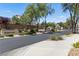 Welcoming entrance to Arlington West, featuring lush landscaping and a gated entry at 9004 Harbor Wind Ave, Las Vegas, NV 89178