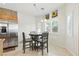 Eat-in kitchen with stainless appliances, tile floor, and large windows at 9004 Harbor Wind Ave, Las Vegas, NV 89178