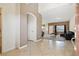 Inviting home with neutral paint, tile flooring, and an arched doorway leading to the living room at 9004 Harbor Wind Ave, Las Vegas, NV 89178