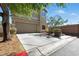 Beige two-story home featuring an attached two-car garage, well-maintained landscaping, and a concrete driveway at 9004 Harbor Wind Ave, Las Vegas, NV 89178