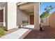 Inviting front porch area with a small seating bench and a decorative front door at 9004 Harbor Wind Ave, Las Vegas, NV 89178
