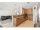 Open kitchen with stainless steel appliances and an island flows into the living room at 9004 Harbor Wind Ave, Las Vegas, NV 89178