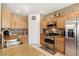 Spacious kitchen showcasing stainless steel appliances, granite counters and light wood cabinets at 9004 Harbor Wind Ave, Las Vegas, NV 89178