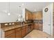 A well-lit kitchen featuring granite countertops, stainless steel appliances, and stylish tile backsplash at 9004 Harbor Wind Ave, Las Vegas, NV 89178