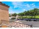 Balcony view of a green area, trees, and parked cars at 9112 Picturesque Ave, Las Vegas, NV 89149