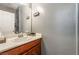Bathroom features a wood vanity with a cream countertop, oval sink, and a neutral-colored wall at 9112 Picturesque Ave, Las Vegas, NV 89149