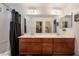 Bright primary bathroom featuring double sinks and a shared shower and bathtub at 9112 Picturesque Ave, Las Vegas, NV 89149