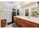 Bright bathroom featuring a double sink vanity, walk-in shower, and tile flooring at 9112 Picturesque Ave, Las Vegas, NV 89149