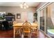 Bright dining area features a wooden table and sliding glass doors to the backyard at 9112 Picturesque Ave, Las Vegas, NV 89149