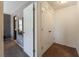 Hallway with a gray carpet leads to the closet and additional bedroom; white doors and light-colored walls at 9112 Picturesque Ave, Las Vegas, NV 89149