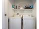 Laundry room with a white washer, dryer, and upper shelf at 9112 Picturesque Ave, Las Vegas, NV 89149