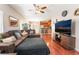 Spacious living room featuring hardwood floors, ceiling fan, and open layout at 9112 Picturesque Ave, Las Vegas, NV 89149