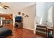 Open-concept living room with hardwood floors, ceiling fan, and staircase to upper level at 9112 Picturesque Ave, Las Vegas, NV 89149