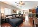 Spacious living room with hardwood floors, comfortable seating, and backyard view at 9112 Picturesque Ave, Las Vegas, NV 89149