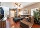 Cozy living room with hardwood floors, comfortable seating, and natural light at 9112 Picturesque Ave, Las Vegas, NV 89149