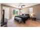 Spacious bedroom with sliding glass doors leading to balcony with seating at 9112 Picturesque Ave, Las Vegas, NV 89149