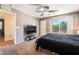 Bedroom featuring a ceiling fan and glass doors with views of the surrounding scenery at 9112 Picturesque Ave, Las Vegas, NV 89149
