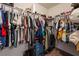 Walk-in closet featuring a variety of clothing hung neatly on shelves at 9112 Picturesque Ave, Las Vegas, NV 89149