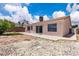 Exterior view of backyard features desert rock landscaping and sliding glass door at 918 Ambusher St, Henderson, NV 89014