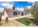 View of backyard featuring artificial turf, rock landscaping, and concrete patio at 918 Ambusher St, Henderson, NV 89014