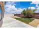 View of backyard featuring concrete patio, artificial turf, and block wall at 918 Ambusher St, Henderson, NV 89014