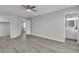 Spacious room showcasing gray flooring, ceiling fan, and a bathroom entrance at 918 Ambusher St, Henderson, NV 89014