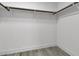 A closet with wooden rods, shelf, and light gray flooring at 918 Ambusher St, Henderson, NV 89014