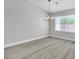Dining area features light gray flooring, modern chandelier, and lots of natural light at 918 Ambusher St, Henderson, NV 89014