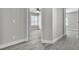 Hallway shot features a bedroom with a ceiling fan, a window, and a neutral color scheme at 918 Ambusher St, Henderson, NV 89014