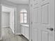 Hallway with doors, a window, and cabinets with light grey flooring at 918 Ambusher St, Henderson, NV 89014