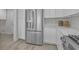 Close-up of the stainless steel refrigerator and white cabinetry in this well-designed kitchen at 918 Ambusher St, Henderson, NV 89014