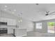 Modern kitchen and bright living space showcasing stainless steel appliances, sleek countertops, and an open floor plan at 918 Ambusher St, Henderson, NV 89014