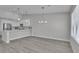 Spacious living area with a modern kitchen, stainless steel appliances, and beautiful hardwood floors at 918 Ambusher St, Henderson, NV 89014