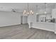 Bright, open living space featuring a modern kitchen, stainless steel appliances, and stylish hardwood flooring at 918 Ambusher St, Henderson, NV 89014