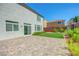 Inviting backyard featuring a brick patio and lush green turf at 10325 Quartz Reef Ct, Las Vegas, NV 89141