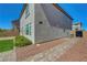 Backyard featuring manicured landscaping and a paved walkway at 10325 Quartz Reef Ct, Las Vegas, NV 89141