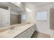 Bathroom with double sinks, long vanity, a bathtub and tile backsplash at 10325 Quartz Reef Ct, Las Vegas, NV 89141