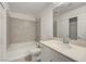 Clean, bright bathroom with white cabinets, single sink and tub with tile surround at 10325 Quartz Reef Ct, Las Vegas, NV 89141