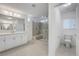 Bright bathroom featuring a glass shower, double vanity, toilet room and modern finishes at 10325 Quartz Reef Ct, Las Vegas, NV 89141