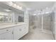 Bright bathroom featuring a glass shower, double vanity, and clean modern finishes at 10325 Quartz Reef Ct, Las Vegas, NV 89141