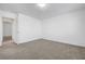 Neutral bedroom with carpeted floors, an attached bathroom and large doorway at 10325 Quartz Reef Ct, Las Vegas, NV 89141