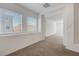 Bedroom features neutral carpet, natural light, and an open doorway to another room at 10325 Quartz Reef Ct, Las Vegas, NV 89141