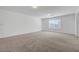 Bonus room features plush carpeting, recessed lighting, and a large window for bright, natural light at 10325 Quartz Reef Ct, Las Vegas, NV 89141