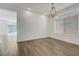 Open dining area featuring wood-look tile floor, contemporary light fixture and bright natural light at 10325 Quartz Reef Ct, Las Vegas, NV 89141